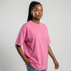 Female model in pink acid wash heavyweight tee, relaxed fit custom apparel for brand merchandise.