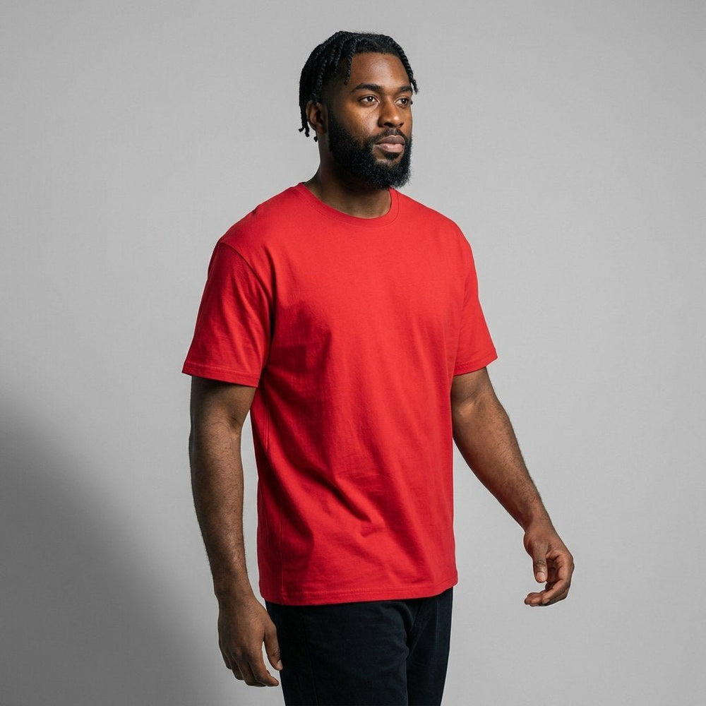Male model walking in a plain bright red short-sleeve t-shirt, high-quality cotton base for company uniforms and brand logos