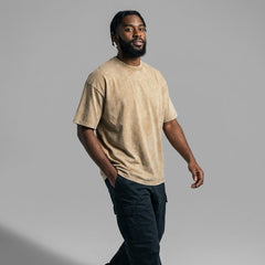 Side profile of beige vintage wash blank t-shirt with drop shoulders and double-needle stitching.