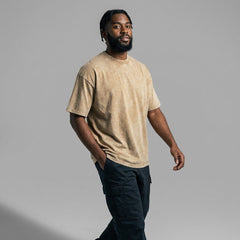 Side profile of beige vintage wash blank t-shirt with drop shoulders and double-needle stitching.