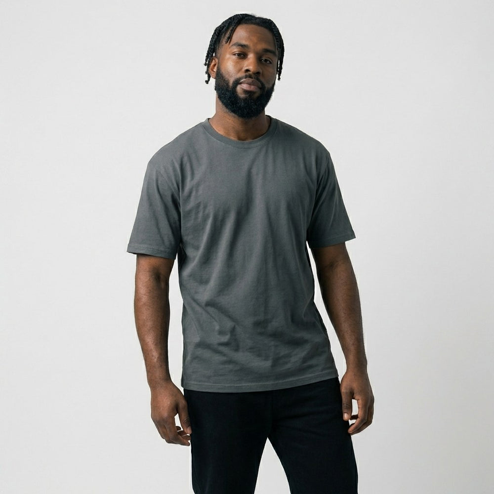 Front view of a male model standing in a charcoal grey blank t-shirt, perfect mockup base for personal brand merchandise and embroidery